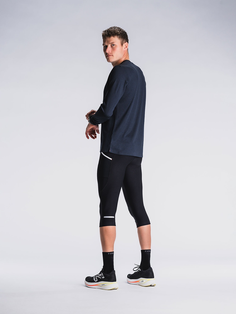 Unisex 3/4 Tights in Schwarz mit seitlicher Oberschenkeltasche und reflektierenden Elementen